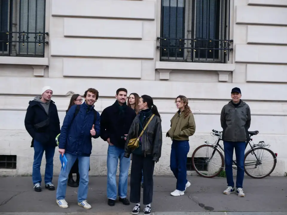 The group listening to the guide in the street