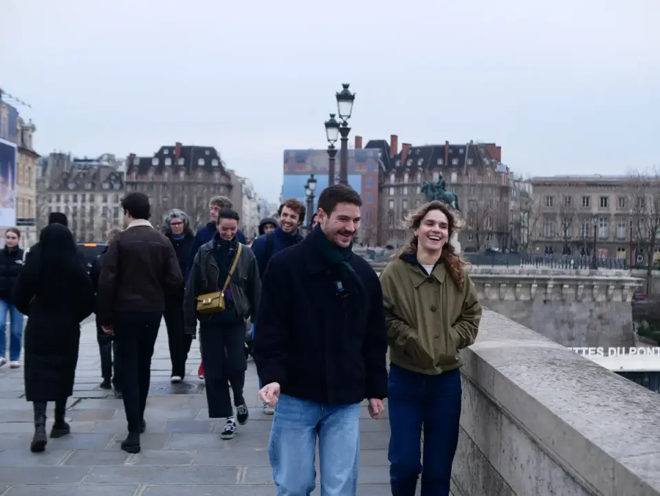 The group crossing a bridge over the Seine