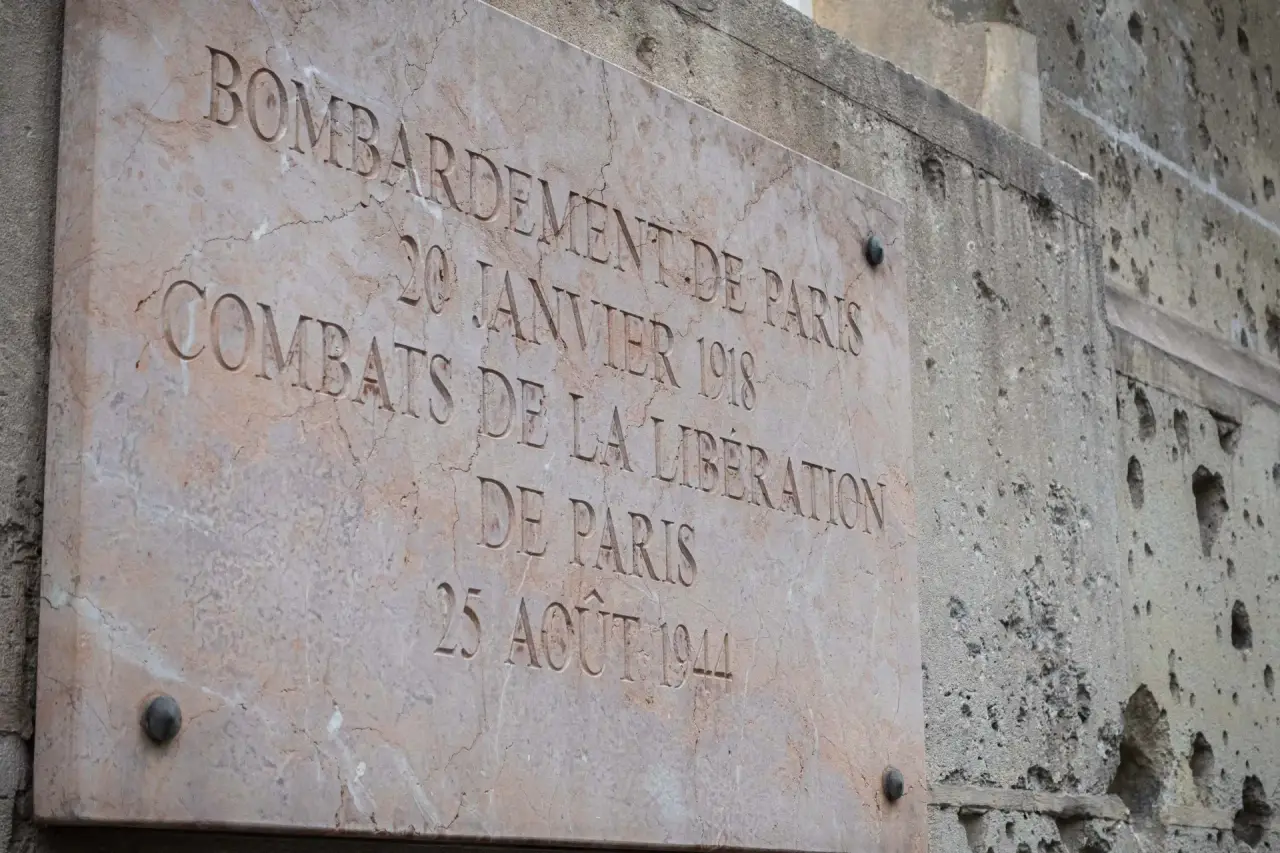 Bullet-scarred façade of the École des Mines on boulevard Saint-Michel, with its plaque commemorating the fighting of August 25, 1944