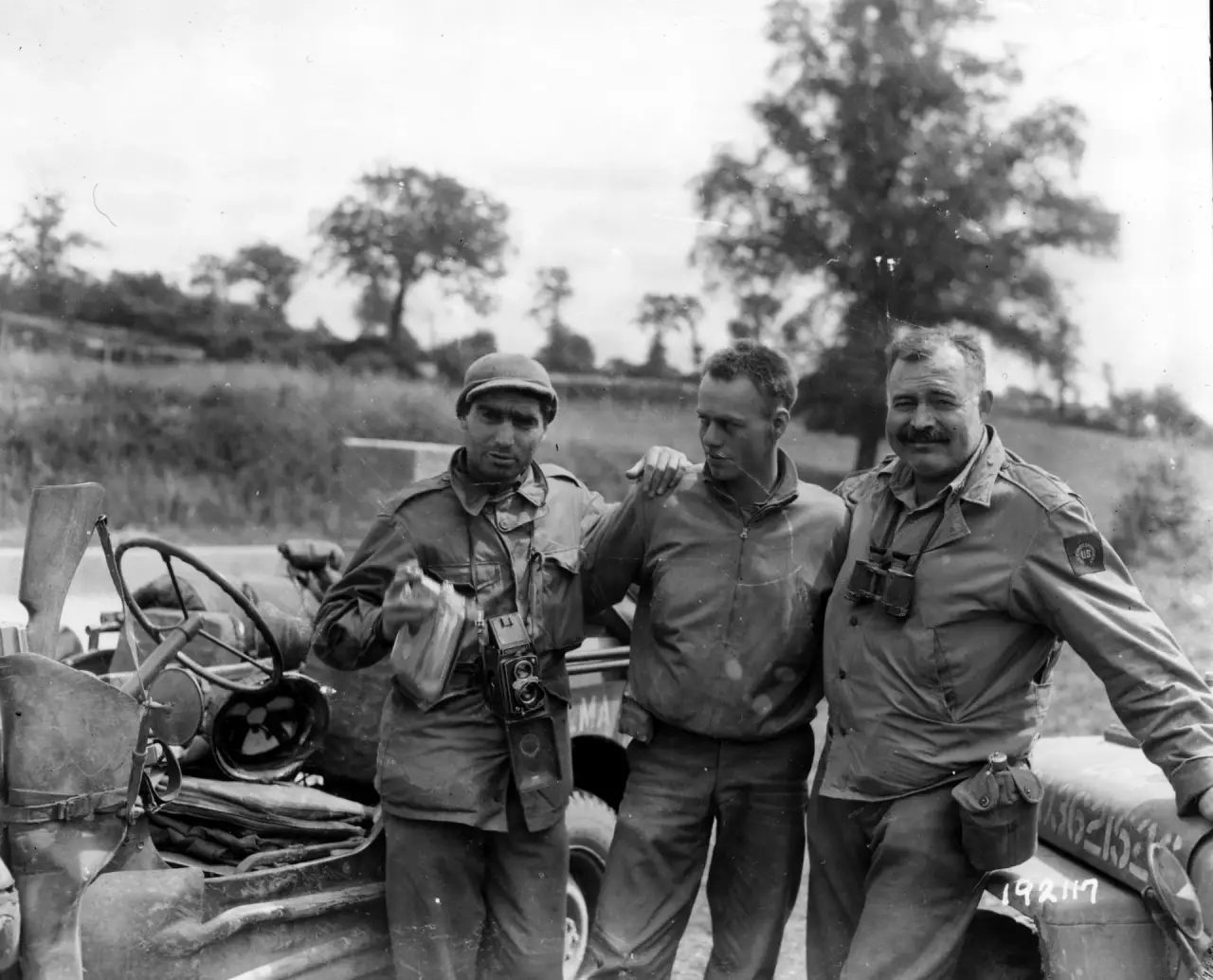 Ernest Hemingway (right), war correspondent for Collier's, with photographer Robert Capa (left) and their driver in Normandy, July 30, 1944 (U.S. Army Signal Corps)