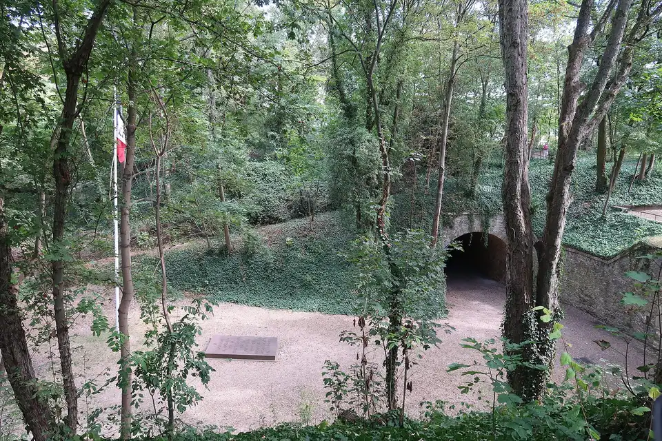 The clearing of the executions at Mont-Valérien, in Suresnes, with its memorial slab and a French flag among the trees